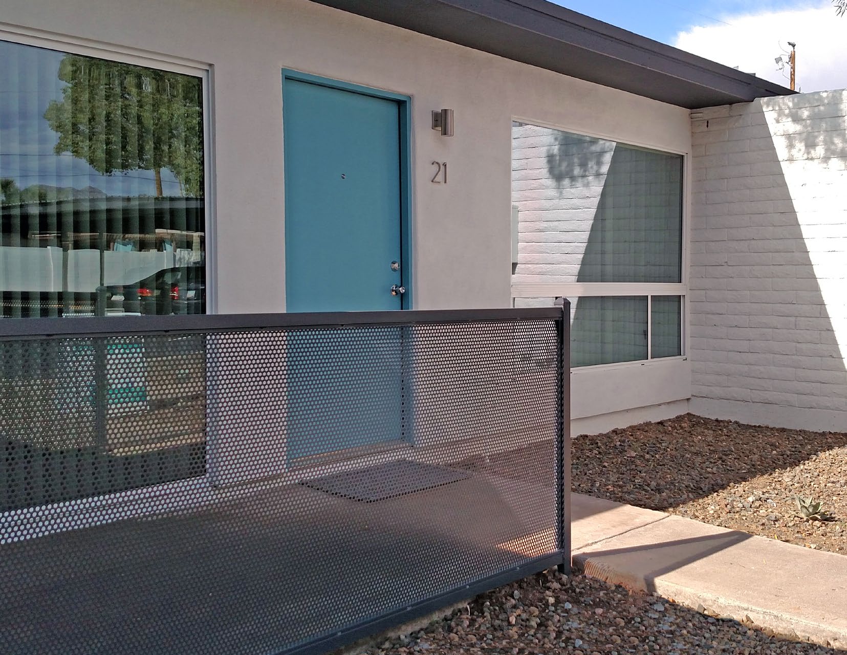 New blue door and perforated metal fence