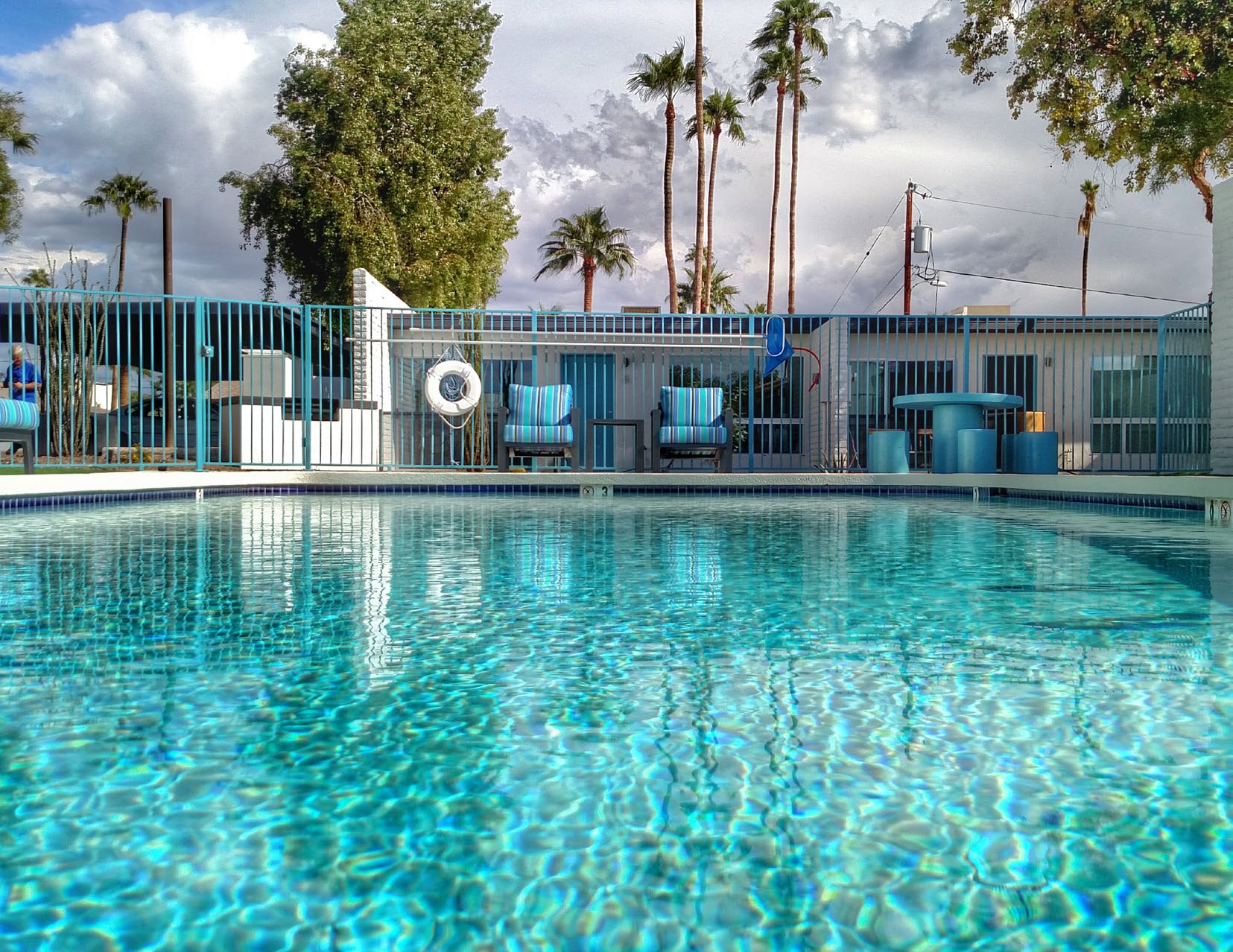 Renovated pool area with teal fencing